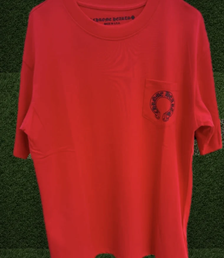 Red Chrome Hearts horse shoe tee on turf